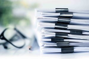 extremely close up stacking of office working document with paper clip folder